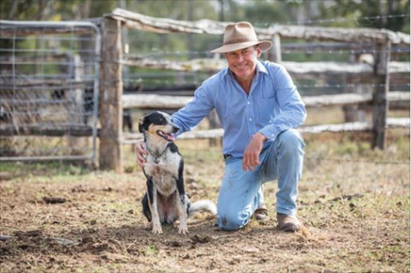 Carl Hendrick and his faithful dog Shadow posing for a photo in the cattle yards.